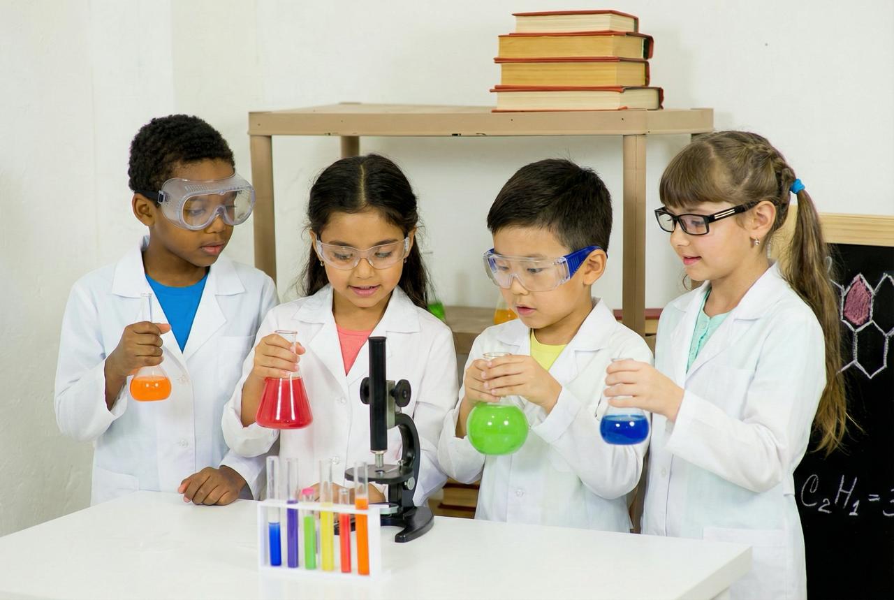 Young children doing fun science experiments with colorful liquids