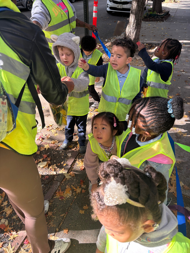 Two By Two Childcare children on an outdoor field trip wearing safety vests